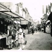 Stoppelhaene 1955 Herenstraat met kramen voor de winkels.jpg